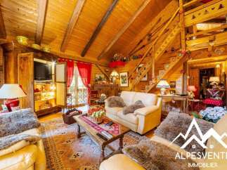 Experience rustic charm in this cozy wooden living room, featuring a plush sofa, a traditional coffee table, and a built-in entertainment center.