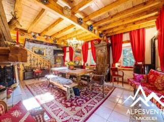 Experience rustic charm in this inviting dining room, featuring a large wooden table perfect for gatherings and a cozy fireplace for warm evenings.