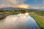 Experience serene living with this stunning property featuring a tranquil river flowing through lush green landscapes.
