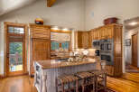 Experience rustic charm in this spacious kitchen featuring custom wood cabinetry and a large granite island perfect for entertaining.