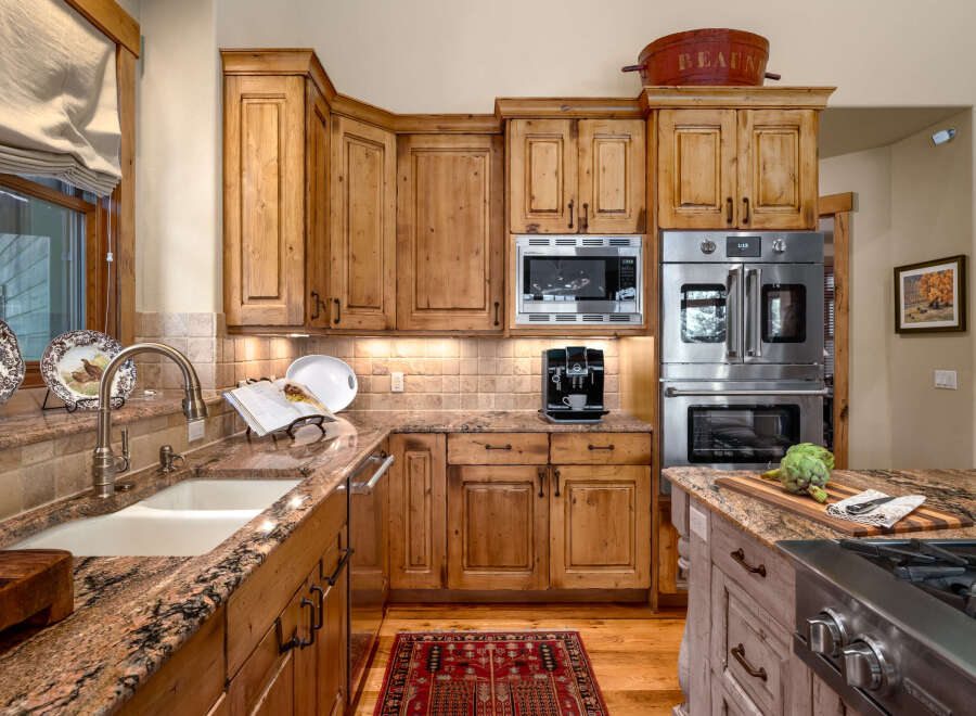 Experience culinary excellence in this stunning kitchen, featuring custom knotty alder cabinetry and luxurious granite countertops.