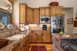Experience culinary excellence in this stunning kitchen, featuring custom knotty alder cabinetry and luxurious granite countertops.