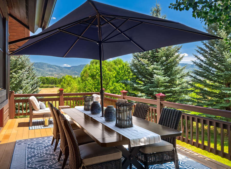 Enjoy breathtaking mountain views from this expansive deck, perfect for outdoor dining and entertaining.