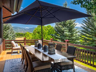Enjoy breathtaking mountain views from this expansive deck, perfect for outdoor dining and entertaining.