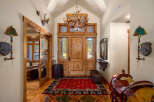 Step into this grand entryway featuring rustic charm and Western-inspired decor.
