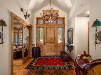 Step into this grand entryway featuring rustic charm and Western-inspired decor.