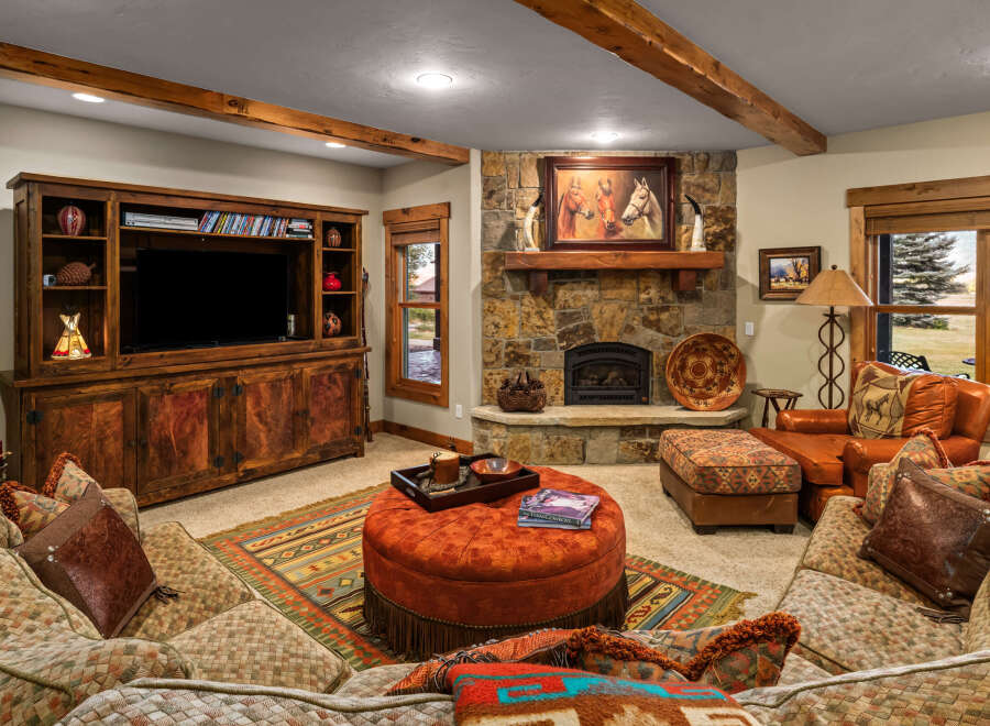 Experience rustic elegance in this inviting living room, featuring a stunning stone fireplace as the centerpiece.