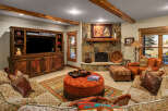 Experience rustic elegance in this inviting living room, featuring a stunning stone fireplace as the centerpiece.