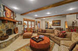 Experience rustic charm in this inviting living room, featuring a grand stone fireplace as the centerpiece.