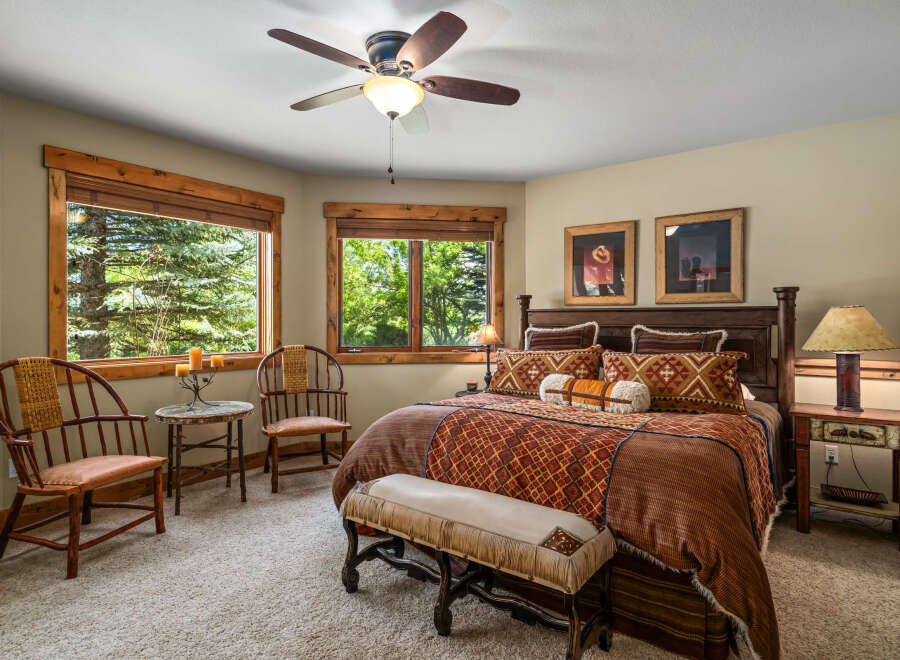 Experience rustic charm in this inviting bedroom, featuring a luxurious king-size bed adorned with Southwestern-inspired textiles.