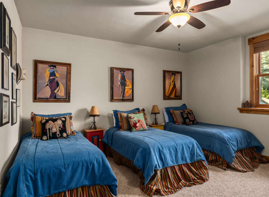 This charming bedroom features three twin beds, perfect for accommodating guests or a growing family.