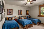 This charming bedroom features three twin beds, perfect for accommodating guests or a growing family.