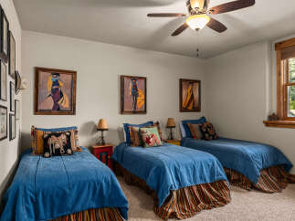 This charming bedroom features three twin beds, perfect for accommodating guests or a growing family.