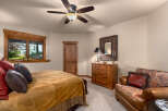 Experience rustic charm in this inviting bedroom, featuring a plush bed adorned with a suede-like throw and decorative pillows.