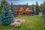 Experience luxury mountain living in this stunning estate, featuring a spacious deck with breathtaking views and a cozy fire pit area perfect for evening gatherings.