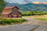 Nestled against a backdrop of majestic mountains, this charming property offers a serene retreat.