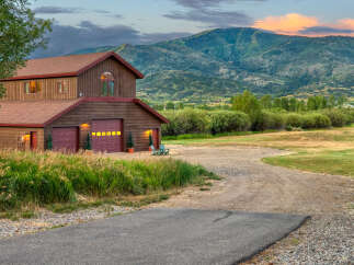 Nestled against a backdrop of majestic mountains, this charming property offers a serene retreat.