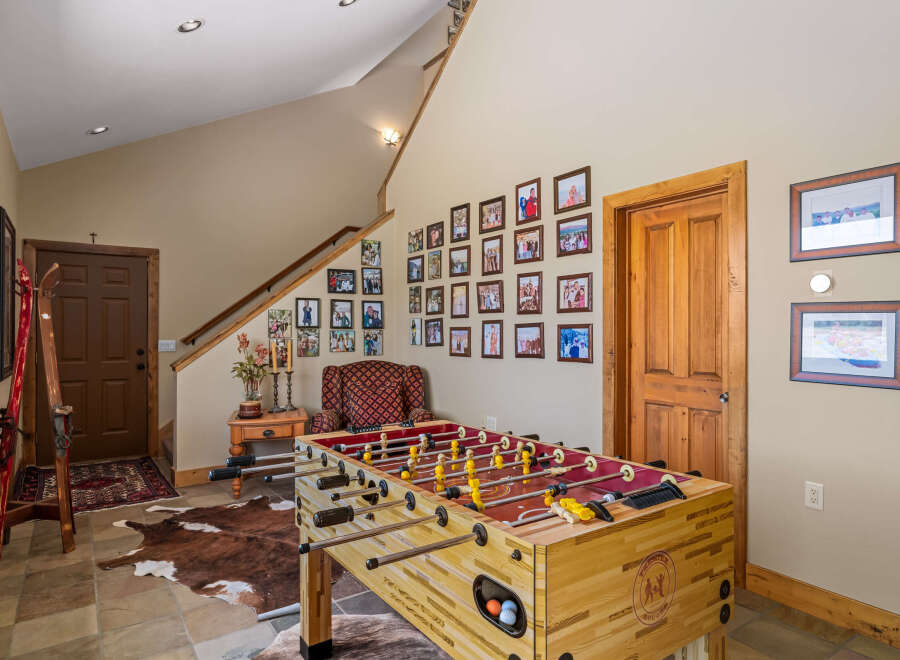 This inviting entryway features a classic foosball table, perfect for family fun and entertainment.