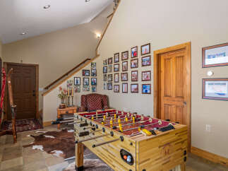 This inviting entryway features a classic foosball table, perfect for family fun and entertainment.