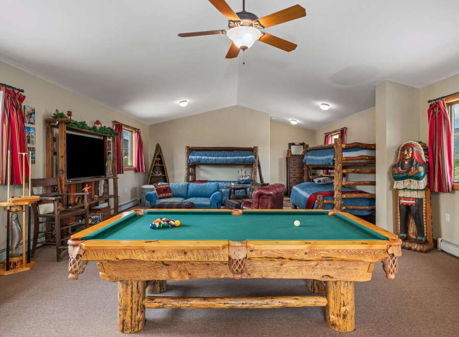 Experience ultimate relaxation and fun in this spacious game room, featuring a professional-grade pool table perfect for friendly competitions.