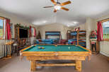 Experience ultimate relaxation and fun in this spacious game room, featuring a professional-grade pool table perfect for friendly competitions.