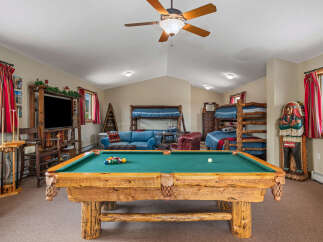 Experience ultimate relaxation and fun in this spacious game room, featuring a professional-grade pool table perfect for friendly competitions.