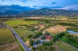 Experience luxury living in this stunning mountain estate, featuring a beautifully lit main residence and a charming guest house.
