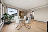 Experience modern dining with this elegant glass-top table and sleek white chairs, perfect for intimate gatherings.