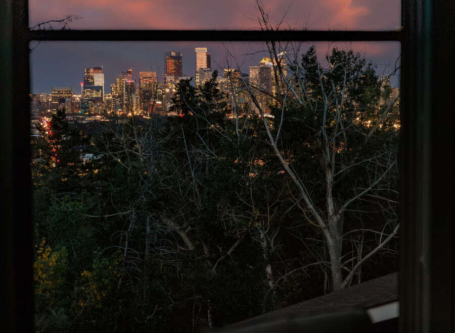 Experience breathtaking city views from this stunning property, perfectly framed by a large window.