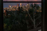 Experience breathtaking city views from this stunning property, perfectly framed by a large window.