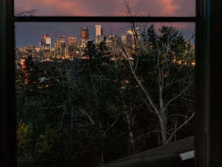 Experience breathtaking city views from this stunning property, perfectly framed by a large window.