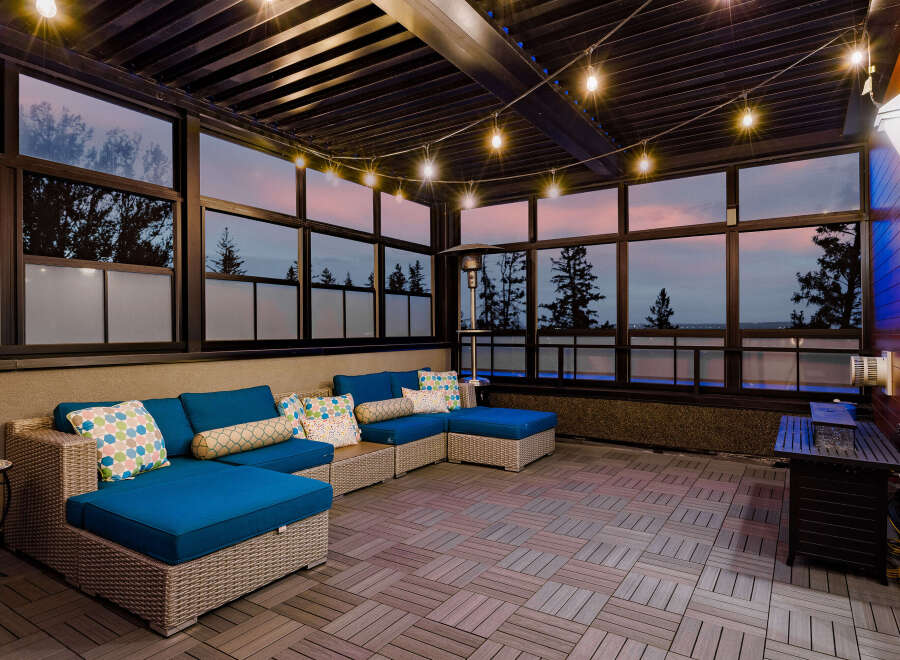 Experience luxurious outdoor living with this stunning covered patio, featuring a spacious sectional sofa perfect for entertaining.