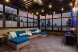 Experience luxurious outdoor living with this stunning covered patio, featuring a spacious sectional sofa perfect for entertaining.