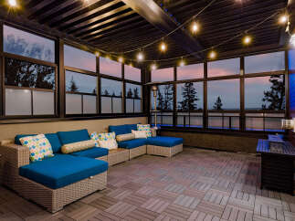 Experience luxurious outdoor living with this stunning covered patio, featuring a spacious sectional sofa perfect for entertaining.