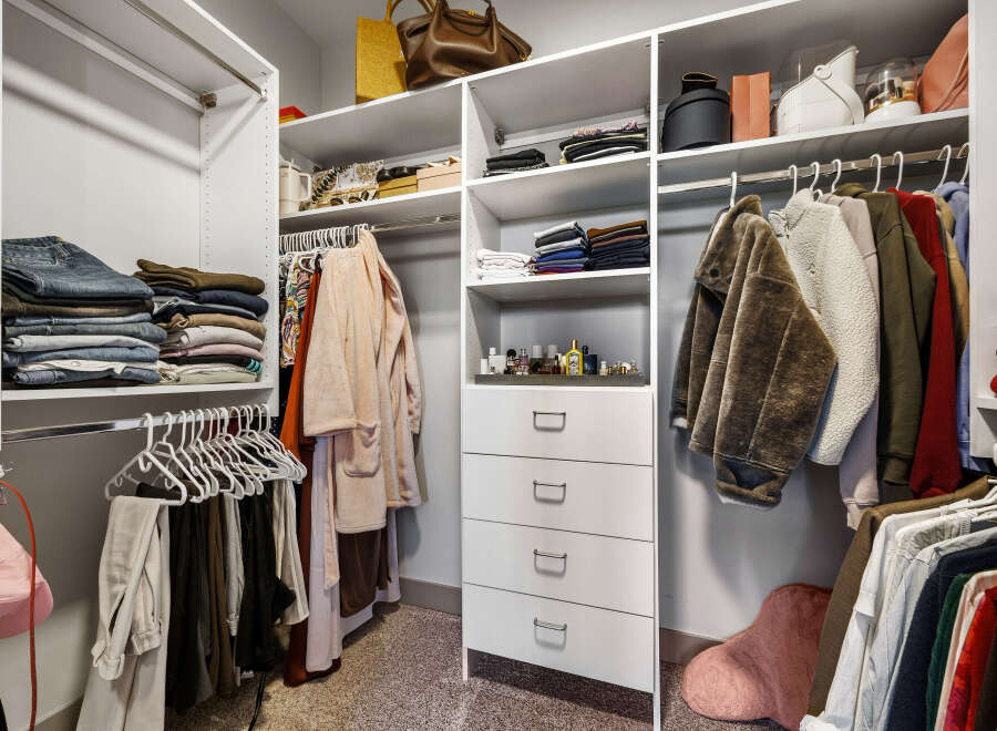 Discover an impeccably organized walk-in closet designed for effortless style.