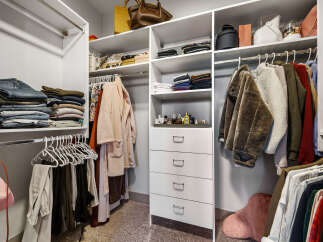 Discover an impeccably organized walk-in closet designed for effortless style.