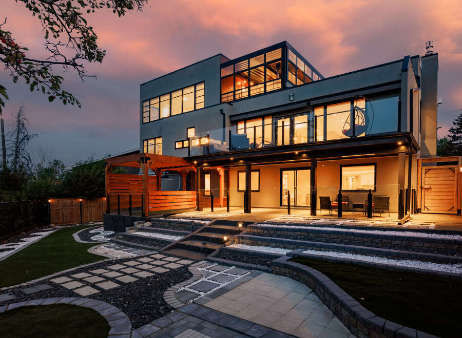 Experience luxury living in this modern architectural masterpiece, featuring expansive windows that flood the interior with natural light and offer stunning sunset views.