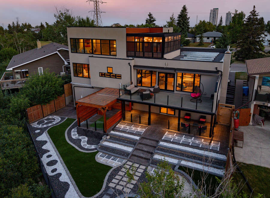 Experience modern luxury in this stunning multi-level home, featuring expansive windows that flood the interior with natural light.