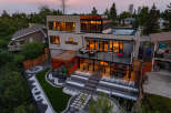 Experience modern luxury in this stunning multi-level home, featuring expansive windows that flood the interior with natural light.