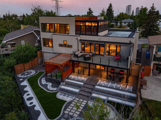 Experience modern luxury in this stunning multi-level home, featuring expansive windows that flood the interior with natural light.