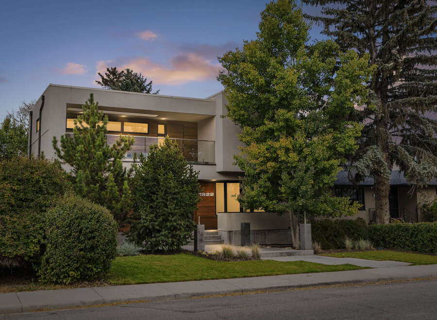 Experience modern luxury in this stunning architectural home, featuring a sleek facade and expansive windows that invite natural light.