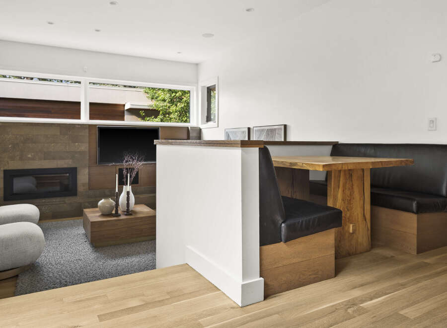 Experience modern living in this beautifully designed space, featuring a sleek fireplace and entertainment center.