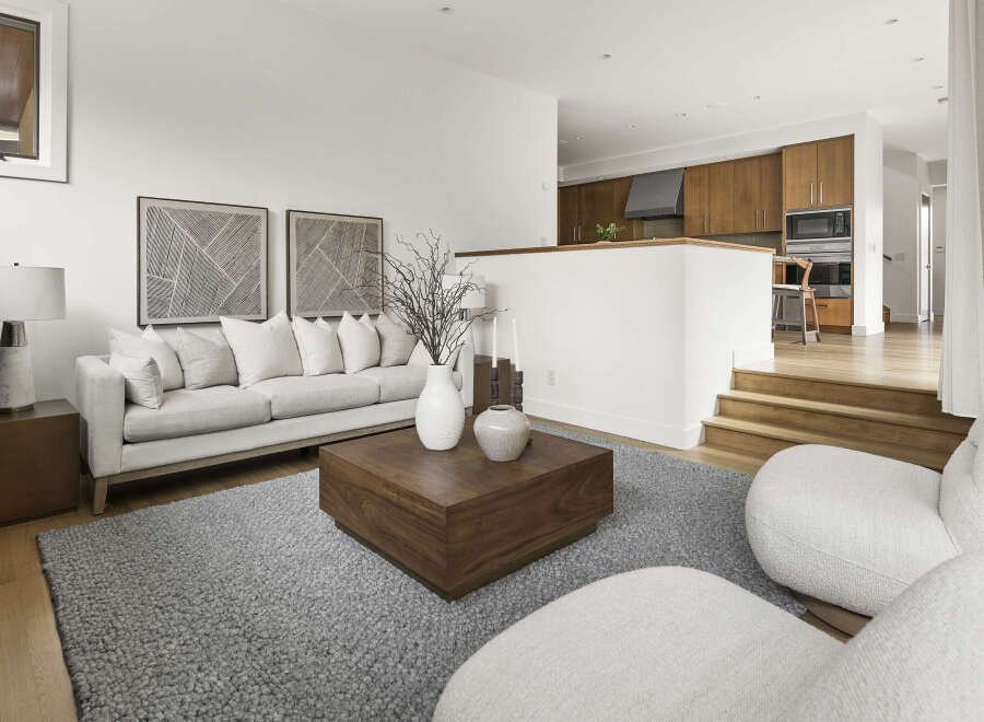 Experience modern living in this beautifully appointed living space, featuring a plush sectional sofa and a striking wooden coffee table.