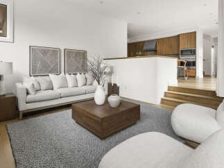 Experience modern living in this beautifully appointed living space, featuring a plush sectional sofa and a striking wooden coffee table.