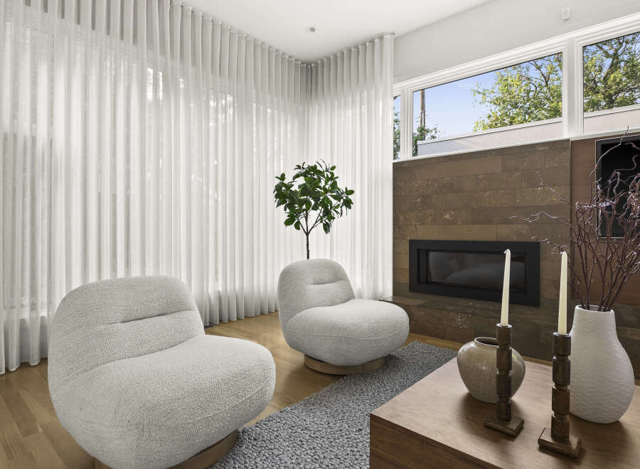 Experience modern living in this stylish living room, featuring two plush armchairs perfect for relaxation.