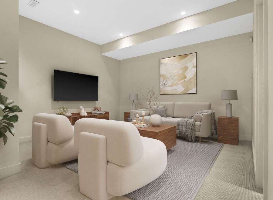 Experience modern living in this beautifully staged living room, featuring plush cream armchairs and a comfortable sofa perfect for relaxation.