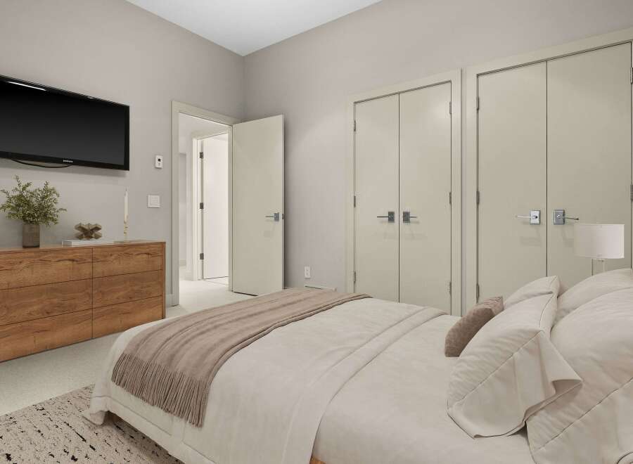 This modern bedroom features a sleek Samsung TV mounted above a stylish wooden dresser, perfect for entertainment.