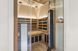 Experience ultimate relaxation in this luxurious infrared sauna, featuring a sleek glass door and natural wood interior.