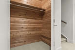 Step into this spacious cedar-lined walk-in closet, offering a natural and aromatic storage solution.