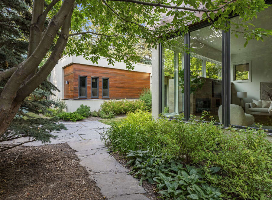 Experience modern living with this stunning home featuring expansive floor-to-ceiling windows that seamlessly blend indoor and outdoor spaces.